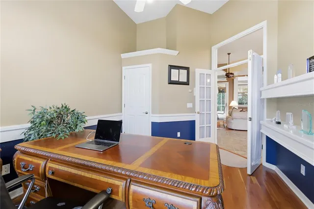a view of a dining room with a table and chairs