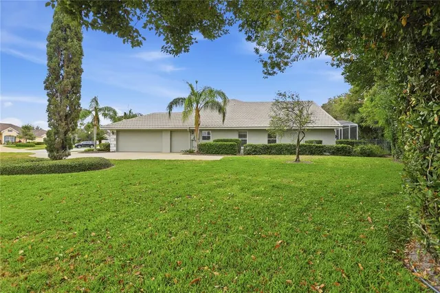 a view of a big house with a big yard and potted plants