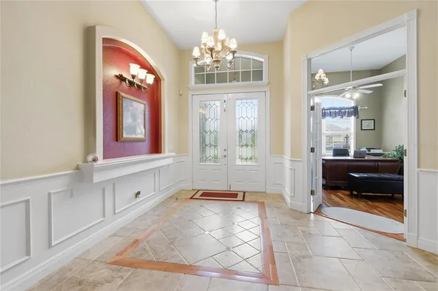 a spacious bathroom with a granite countertop sink a mirror and a bathtub