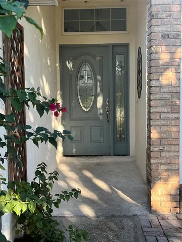 a front view of a house with a potted plant