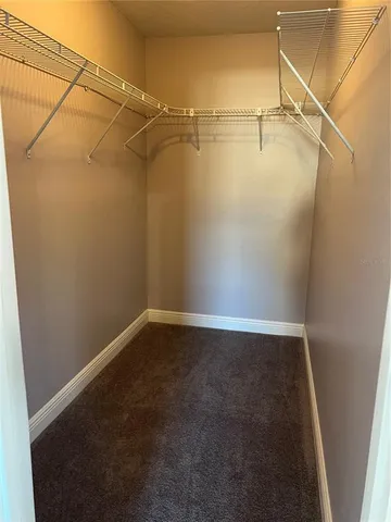 a bathroom with a granite countertop sink a toilet and a mirror