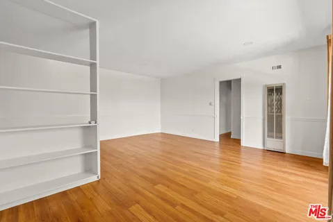 a view of a room with wooden floor