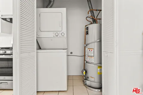 an empty room with wooden floor chandelier fan and windows