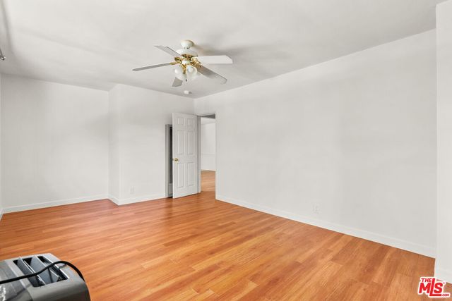 a view of hallway with wooden floor