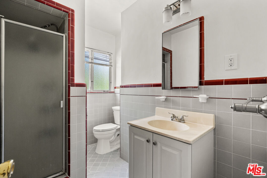 272 South Doheny Drive, Unit 1 Beverly Hills, CA 90211 - Photo 29 of 44 a bathroom with a sink a toilet and mirror