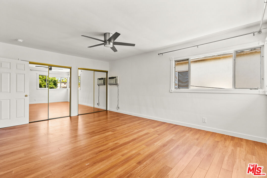272 South Doheny Drive, Unit 1 Beverly Hills, CA 90211 - Photo 33 of 44 a view of an empty room with wooden floor and a window