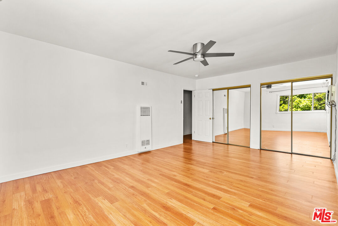 272 South Doheny Drive, Unit 1 Beverly Hills, CA 90211 - Photo 34 of 44 a view of empty room with wooden floor and fan
