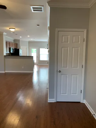 a view of empty room with wooden floor