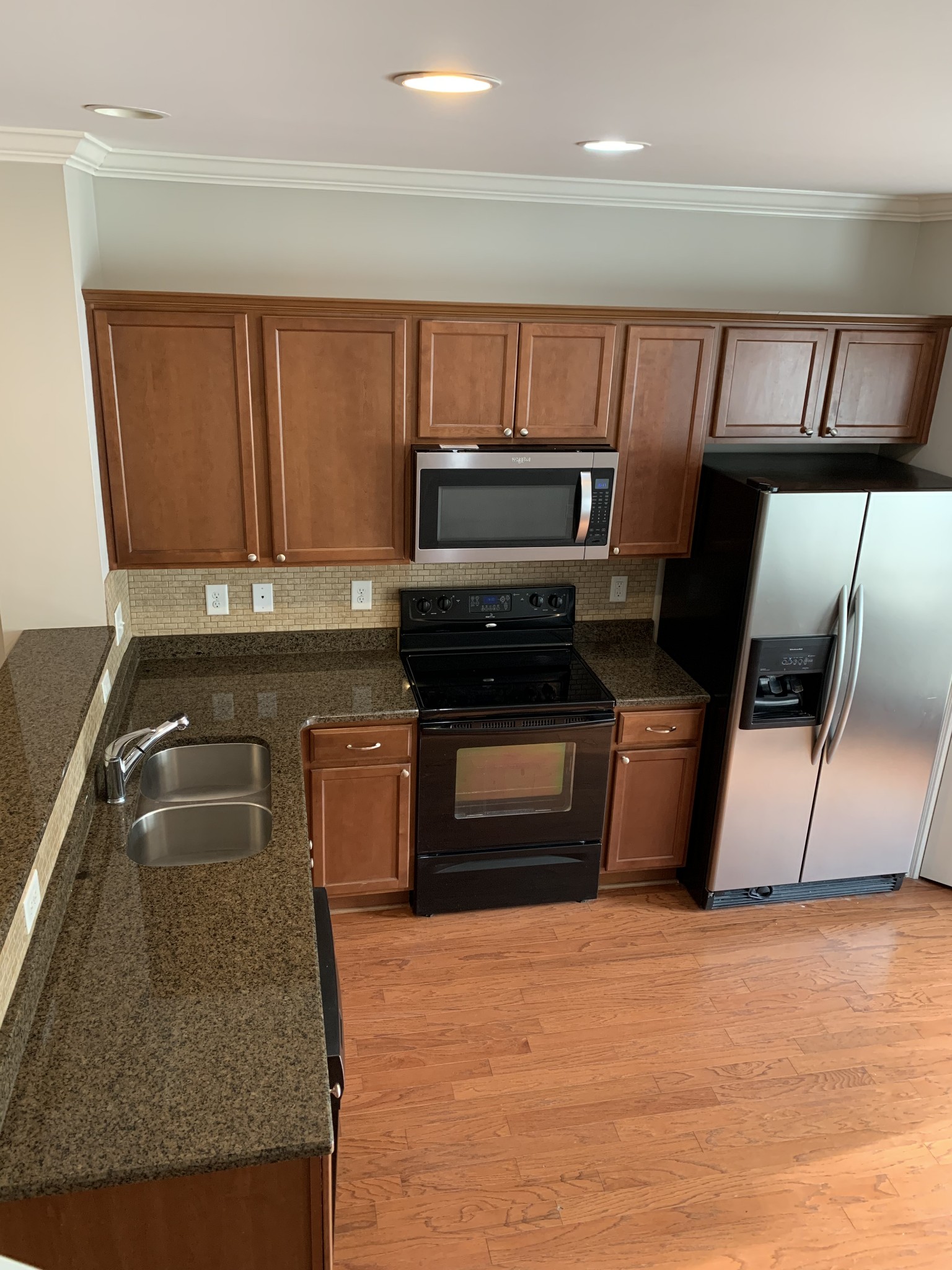 2015 Hemlock Drive Spring Hill, TN 37174 - Photo 5 of 22 a kitchen with granite countertop a refrigerator stove and microwave