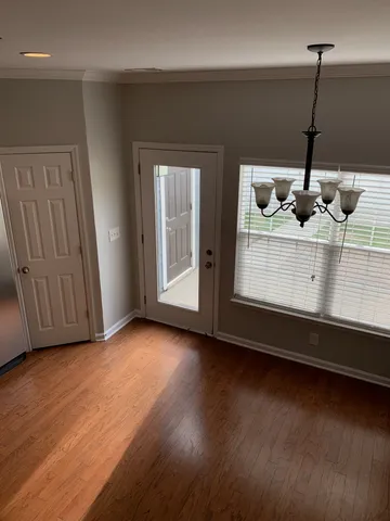 a view of a room with wooden floor