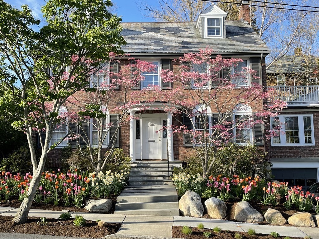 a front view of a house with a garden