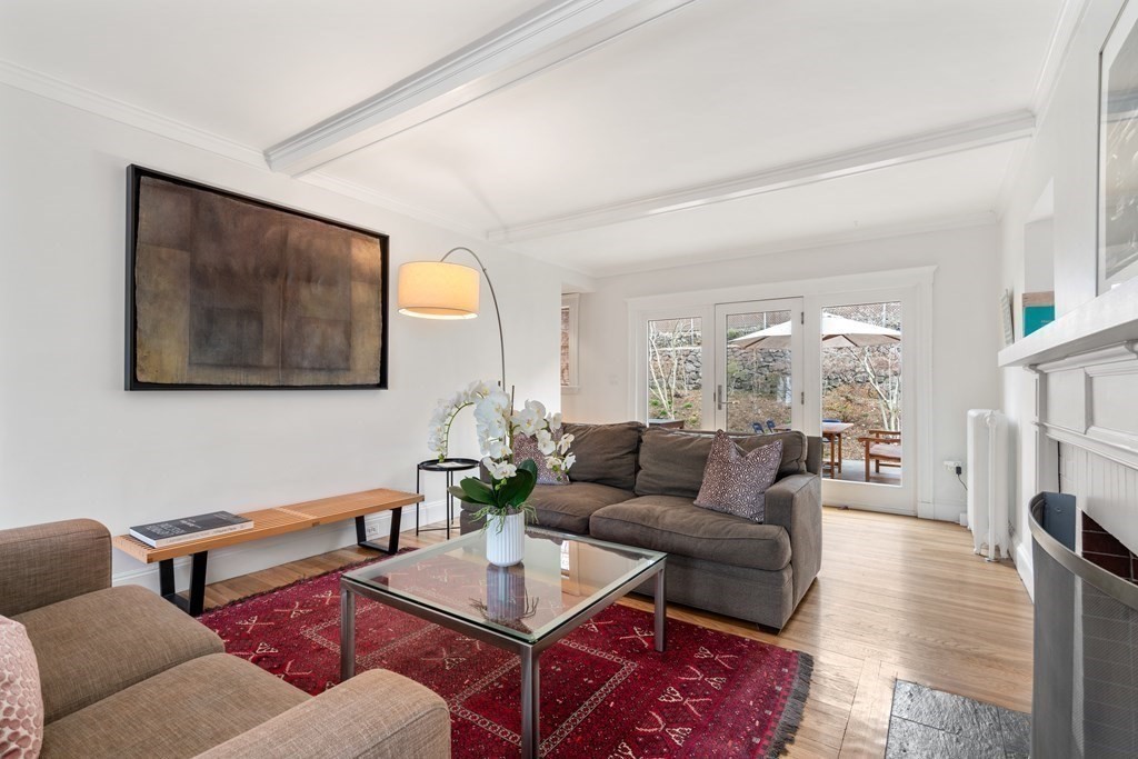 85 Stanton Road Brookline, MA 02445 - Photo 11 of 38 a living room with furniture a fireplace and a table