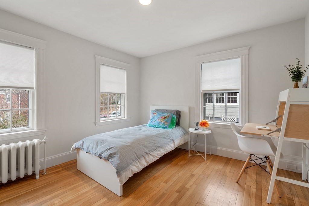 85 Stanton Road Brookline, MA 02445 - Photo 20 of 38 a bedroom with a bed and a chair