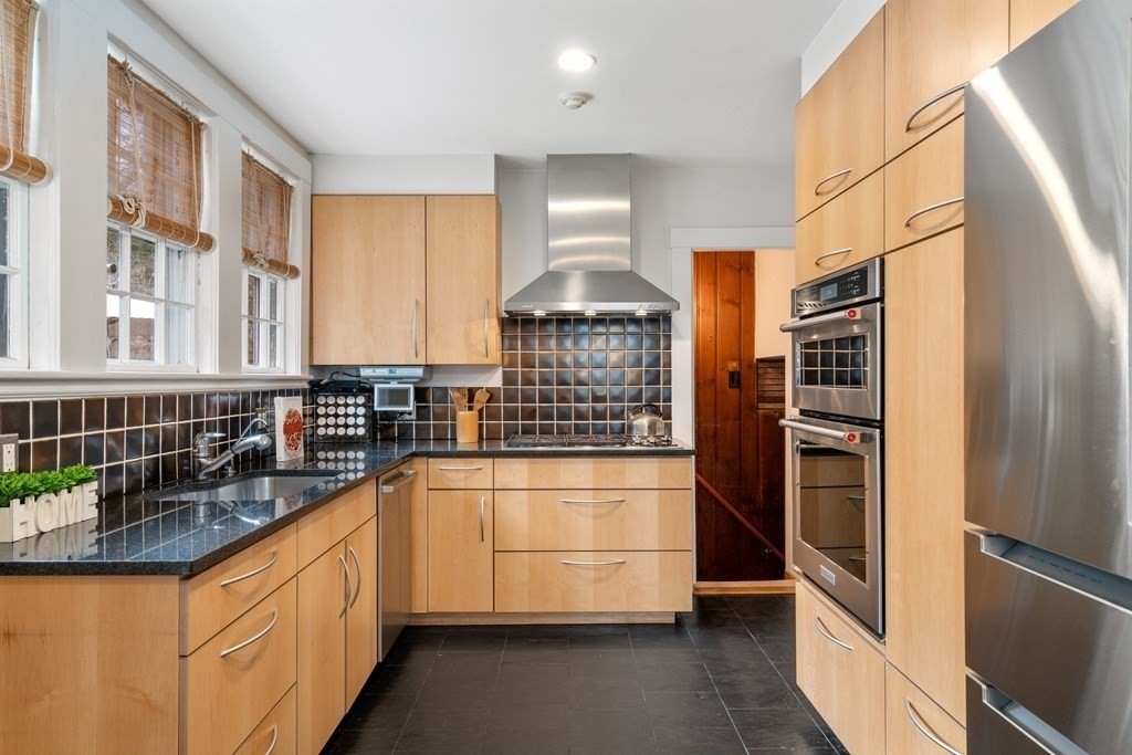85 Stanton Road Brookline, MA 02445 - Photo 5 of 38 a kitchen with stainless steel appliances a refrigerator and a sink