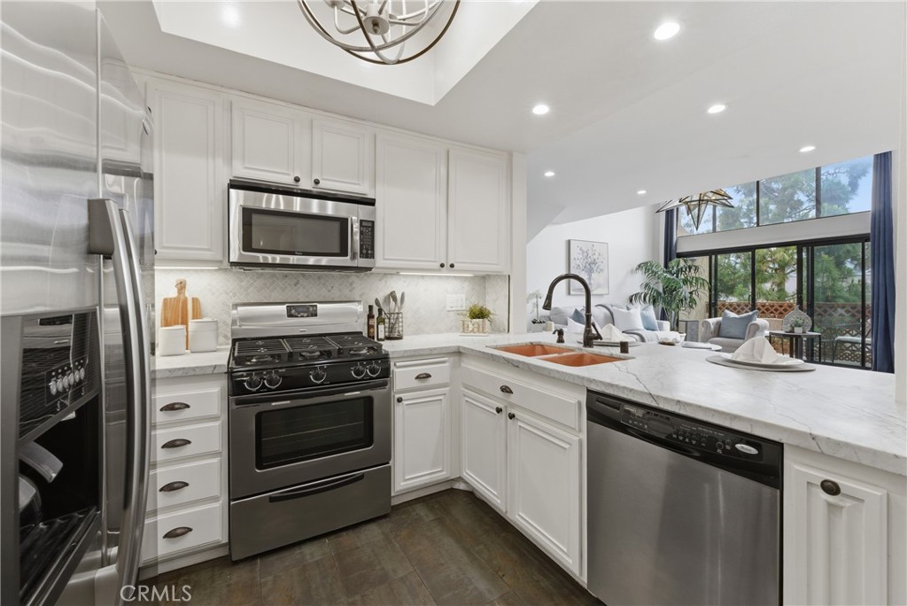 8180 Manitoba Street, Unit 330 Playa del Rey, CA 90293 - Photo 9 of 31 a kitchen with stainless steel appliances a stove sink and microwave