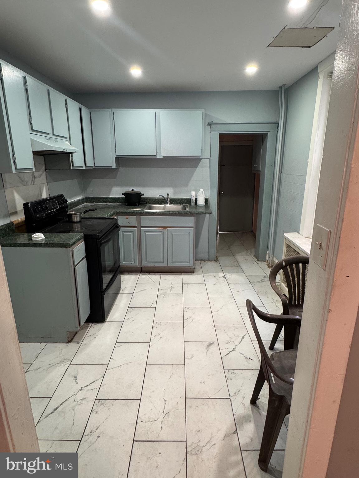 3044 Rorer Street Philadelphia, PA 19134 - Photo 3 of 7 a kitchen with stainless steel appliances granite countertop a stove a sink and a microwave