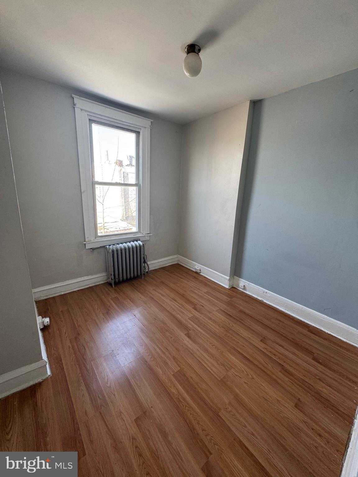 3044 Rorer Street Philadelphia, PA 19134 - Photo 4 of 7 an empty room with wooden floor and windows