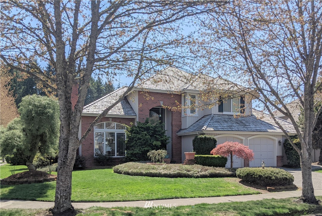 3016 214th Street Southeast Bothell, WA 98021 - Photo 2 of 25 a front view of a house with a yard