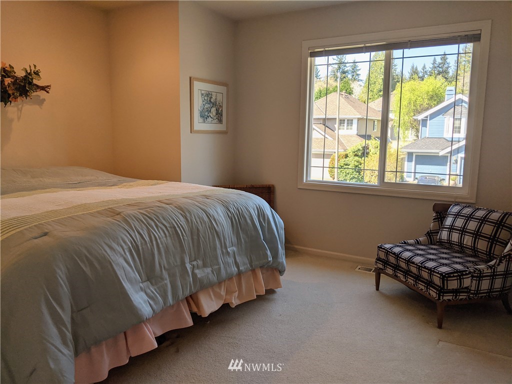 3016 214th Street Southeast Bothell, WA 98021 - Photo 14 of 25 a bed sitting in a bedroom next to a window