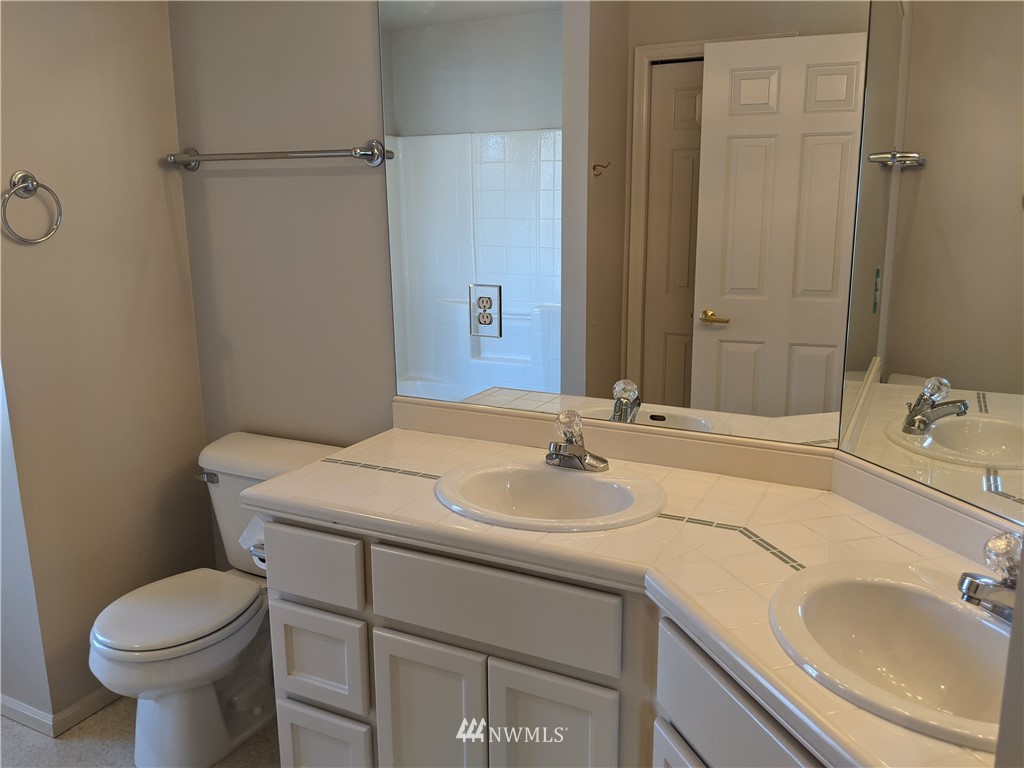 3016 214th Street Southeast Bothell, WA 98021 - Photo 16 of 25 a bathroom with a granite countertop sink a toilet and a mirror