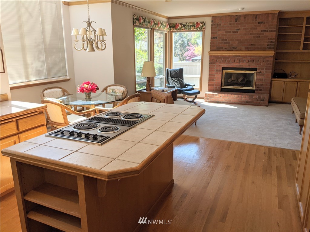 3016 214th Street Southeast Bothell, WA 98021 - Photo 7 of 25 a dining room with a fireplace wooden floor and a fireplace