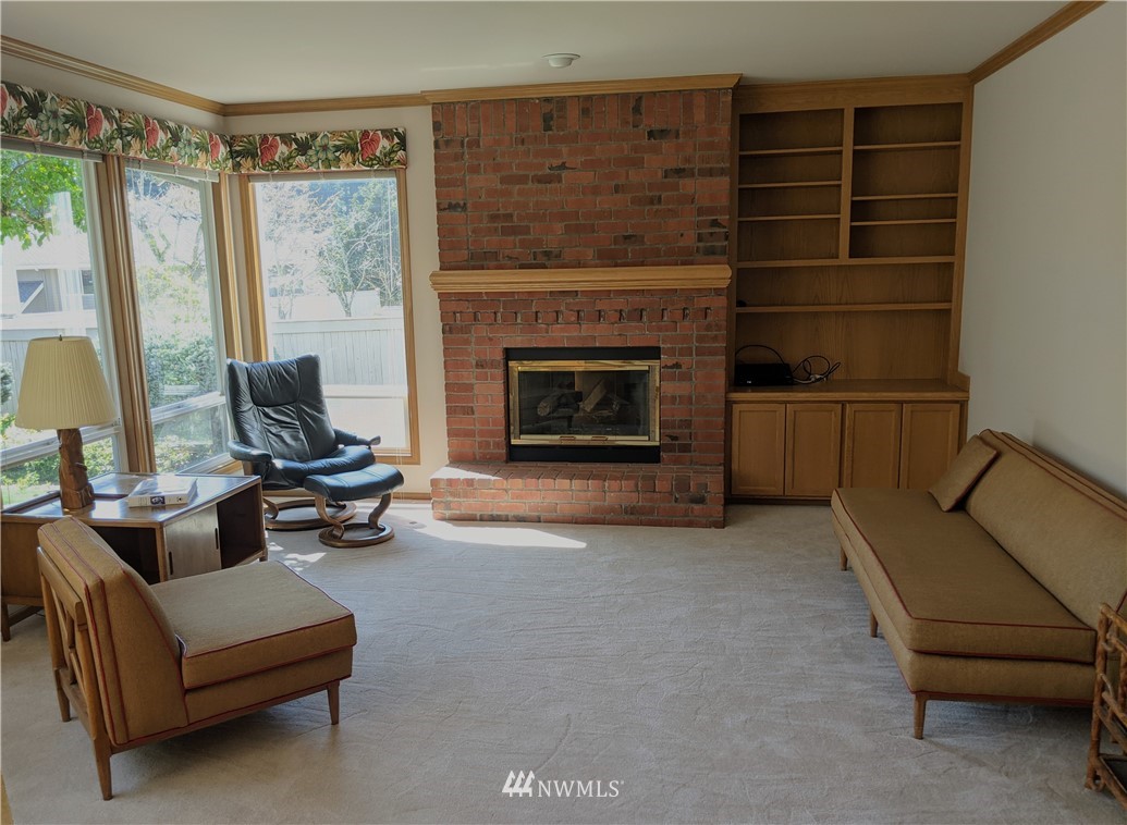 3016 214th Street Southeast Bothell, WA 98021 - Photo 8 of 25 a living room with furniture and a fireplace