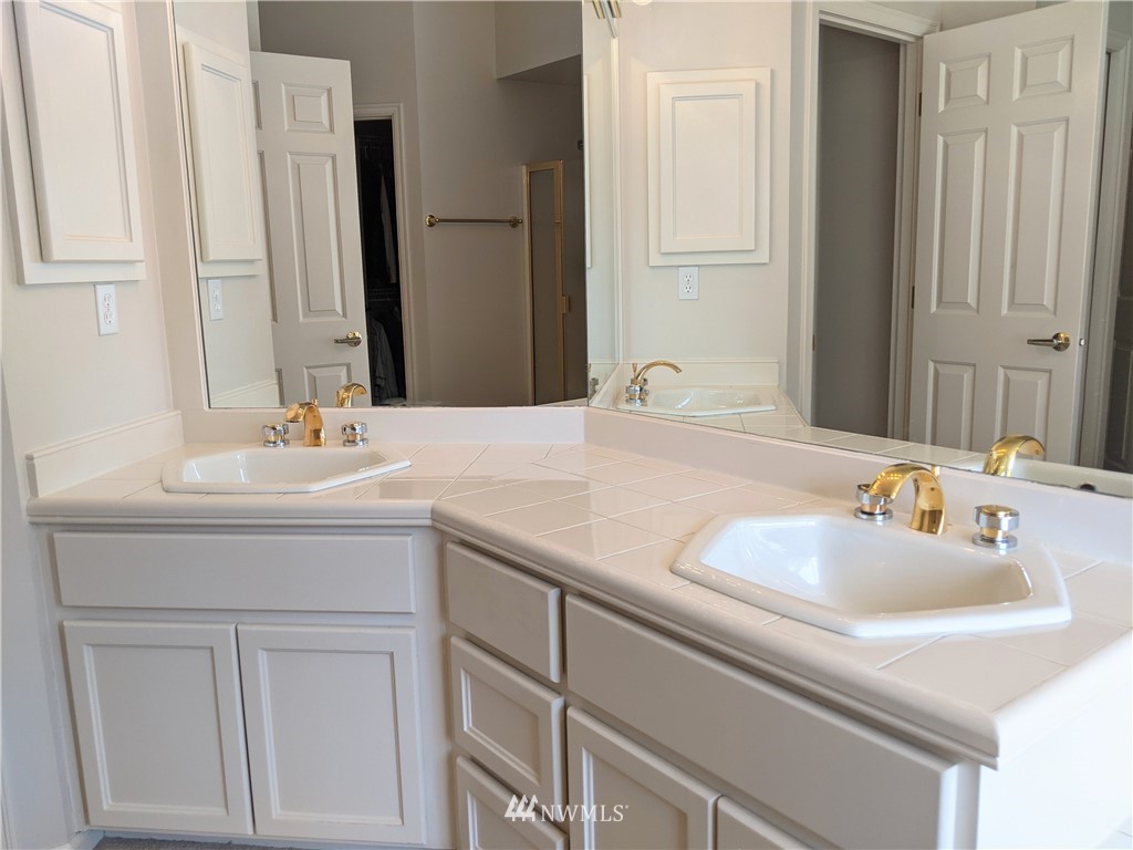 3016 214th Street Southeast Bothell, WA 98021 - Photo 10 of 25 a bathroom with a sink and a mirror