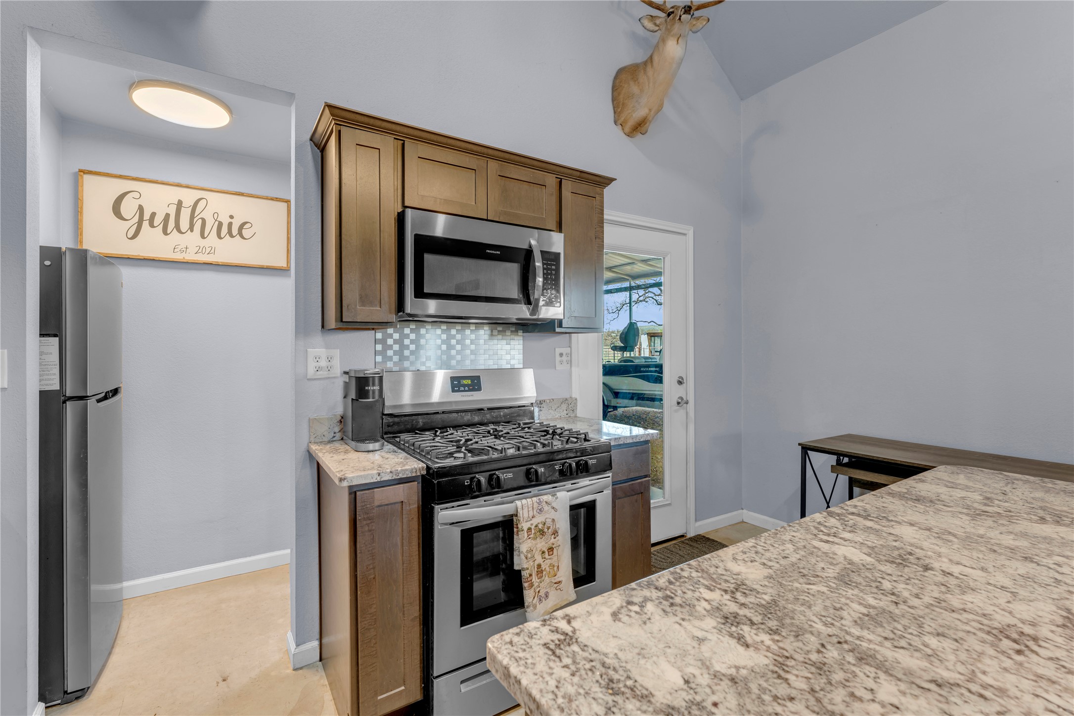 6475 County Road 216 Bluffton, TX 78607 - Photo 26 of 33 a kitchen with stainless steel appliances a stove a microwave and a sink