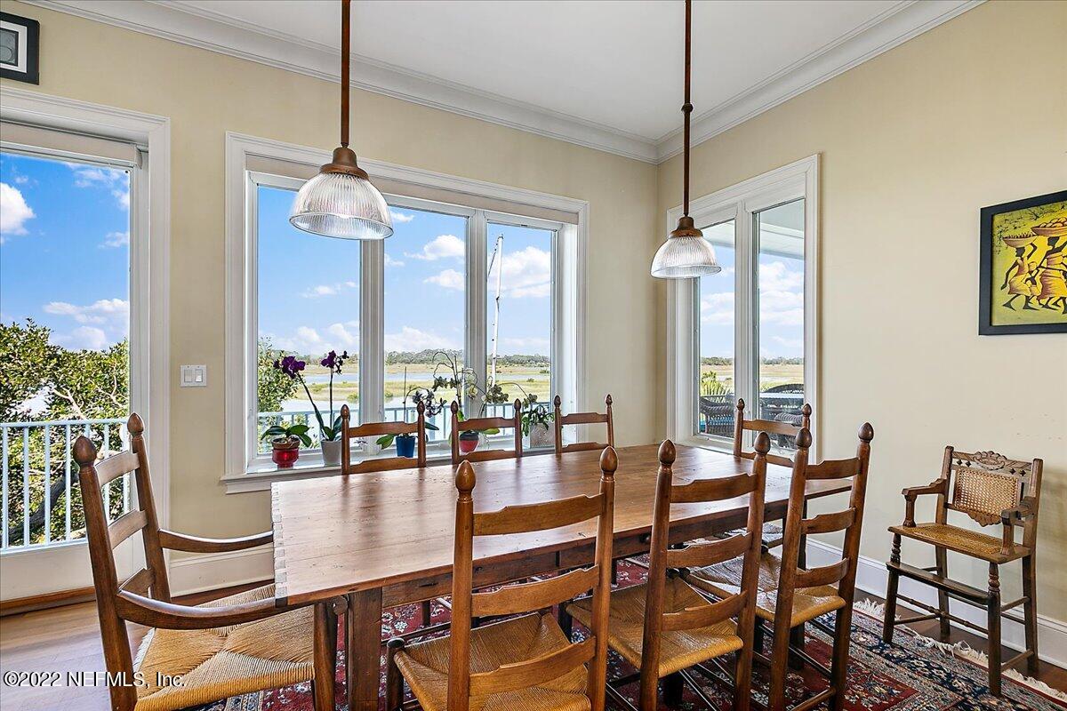 3425 Lands End Drive St. Augustine, FL 32084 - Photo 21 of 79 a dining room with furniture a chandelier and windows