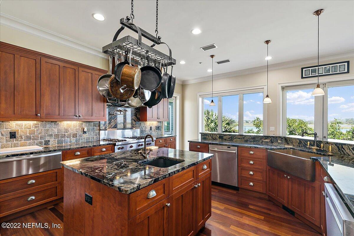 3425 Lands End Drive St. Augustine, FL 32084 - Photo 24 of 79 a kitchen with a stove a sink a counter space and wooden floor
