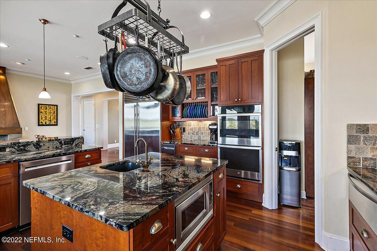 3425 Lands End Drive St. Augustine, FL 32084 - Photo 26 of 79 a kitchen with stainless steel appliances granite countertop a stove and a large refrigerator