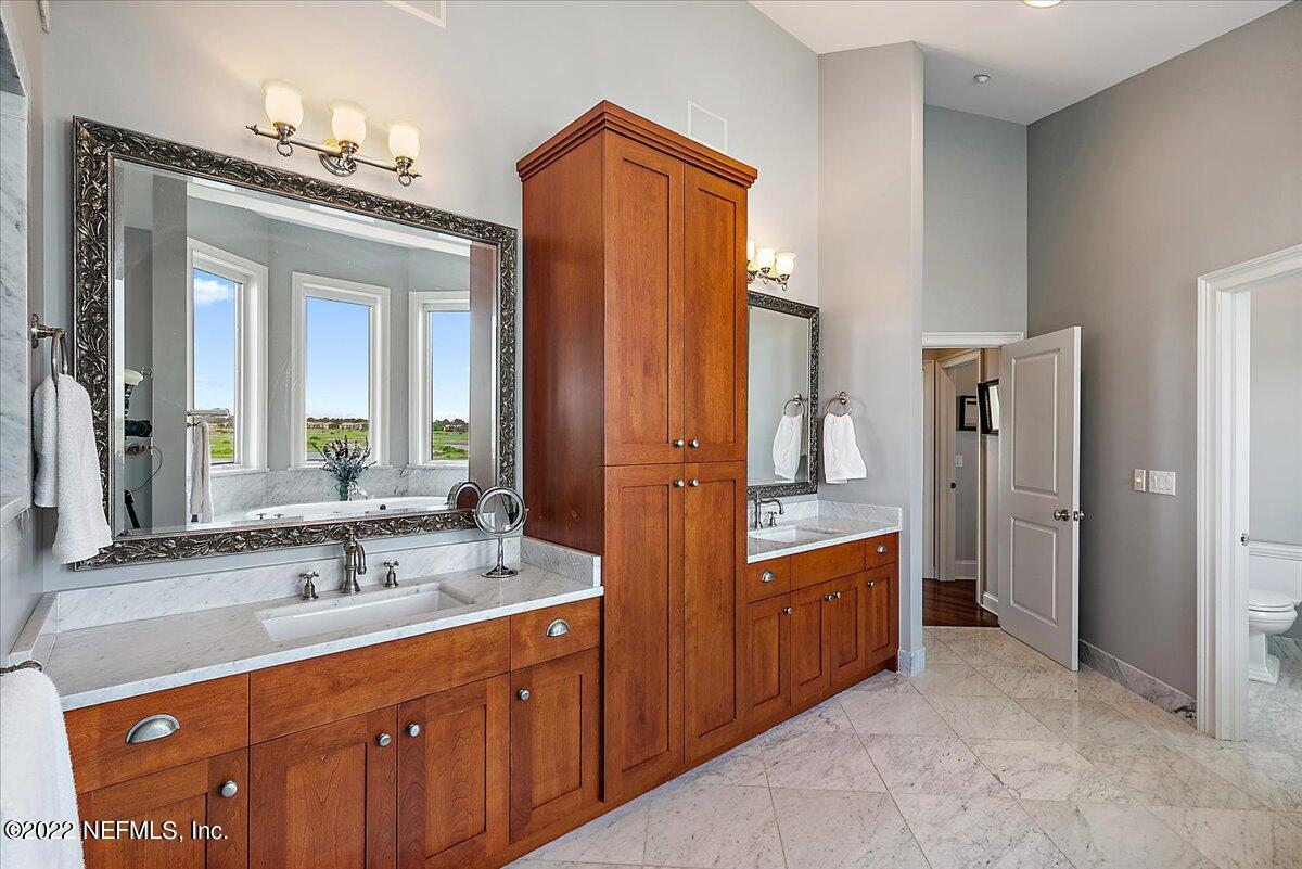 3425 Lands End Drive St. Augustine, FL 32084 - Photo 50 of 79 a spacious bathroom with a double vanity sink and a mirror