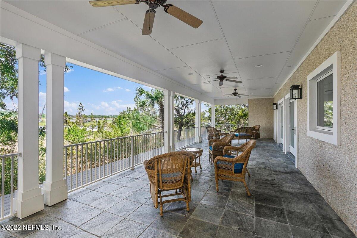 3425 Lands End Drive St. Augustine, FL 32084 - Photo 62 of 79 a view of a porch with furniture and a yard