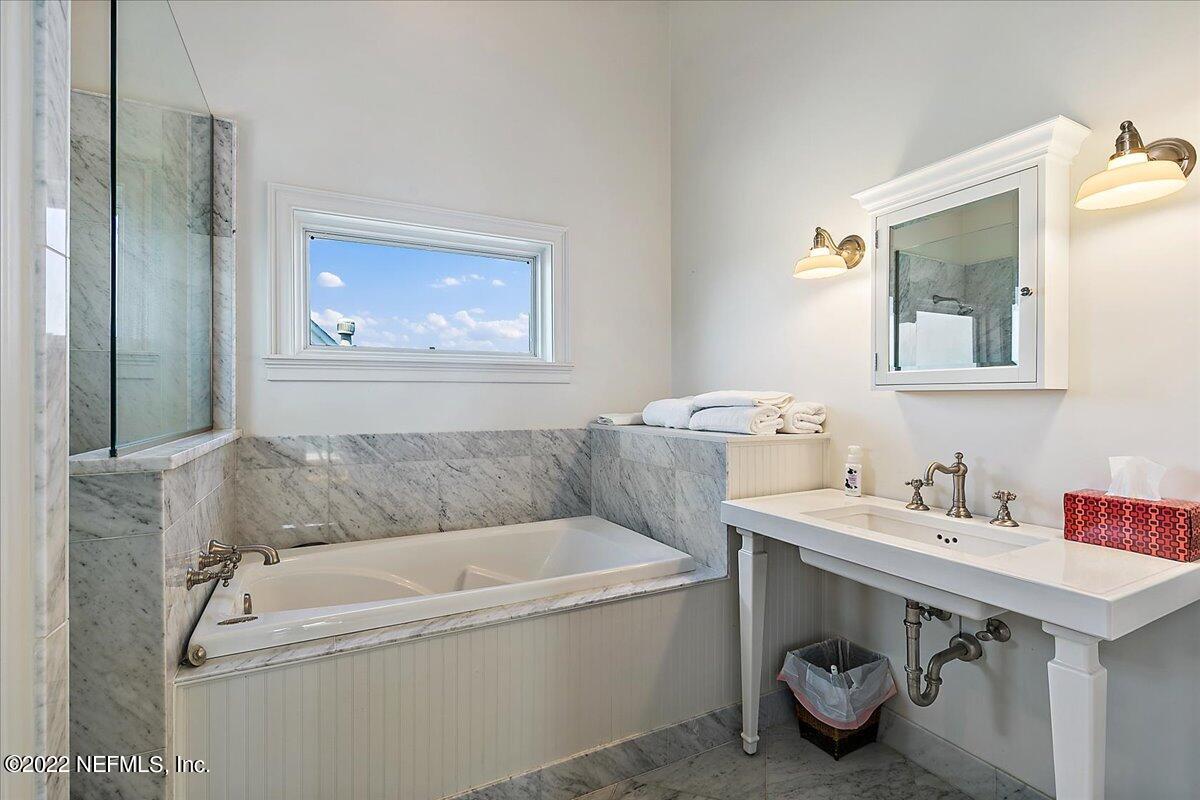 3425 Lands End Drive St. Augustine, FL 32084 - Photo 71 of 79 a bathroom with a tub sink and mirror