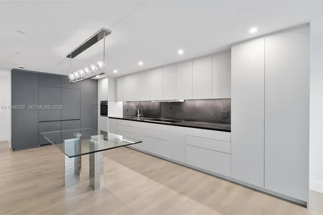 a kitchen with a sink and chandelier