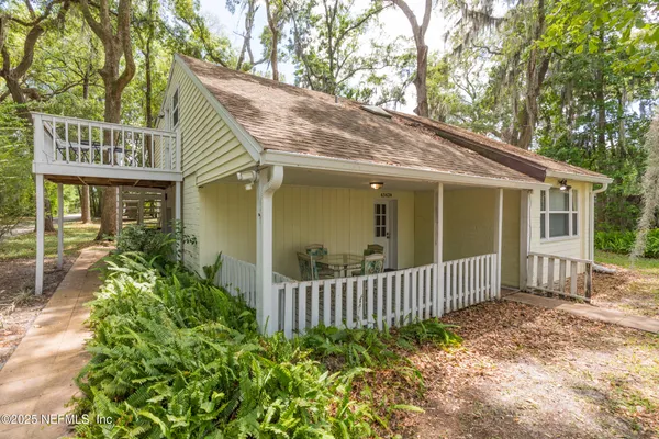 a view of a house with a porch and plants