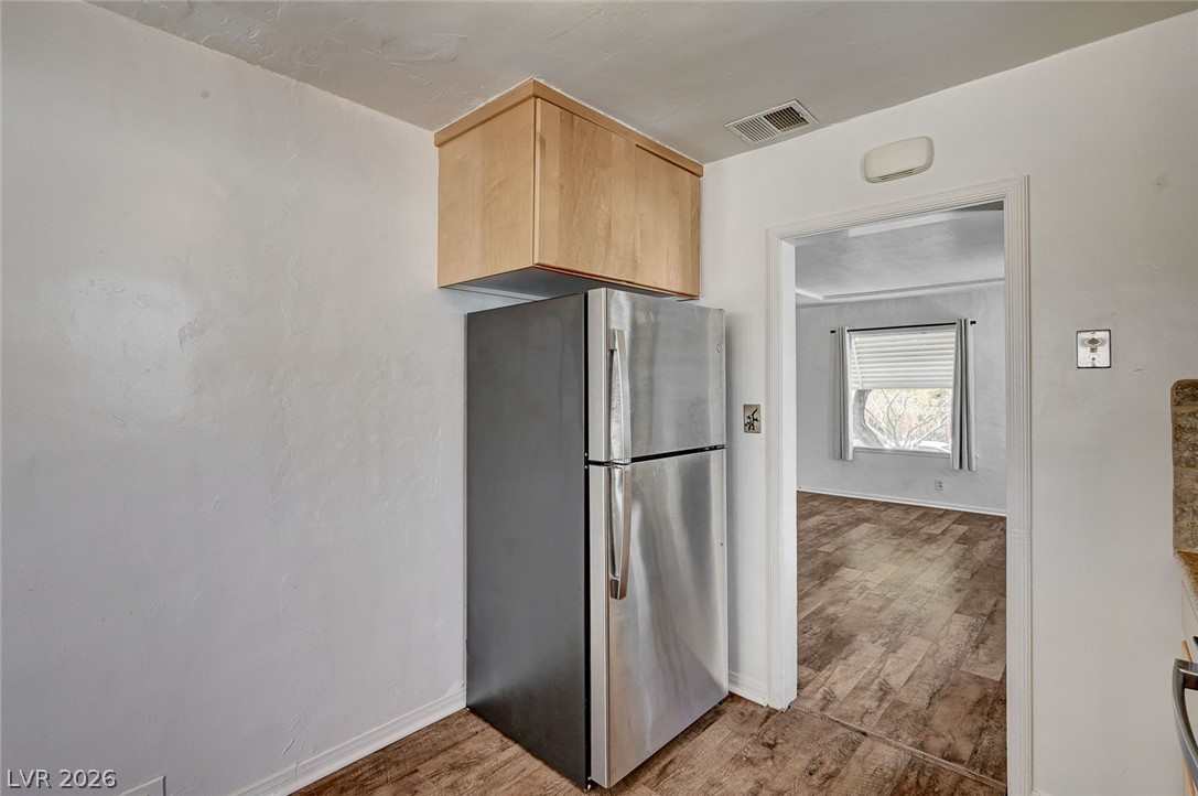 629 L Avenue Boulder City, NV 89005 - Photo 17 of 46 Kitchen with freestanding refrigerator, light wood finish cabinetry, and light wood-type flooring