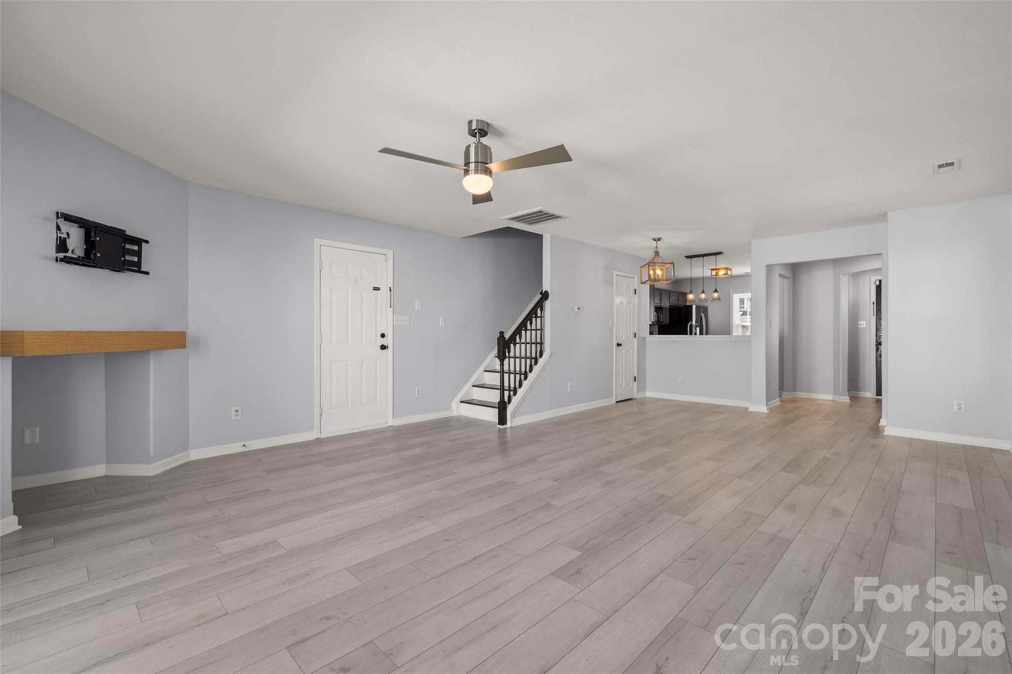 4485 Easywater Lane Fort Mill, SC 29707 - Photo 11 of 29 a view of a livingroom with wooden floor and ceiling fan