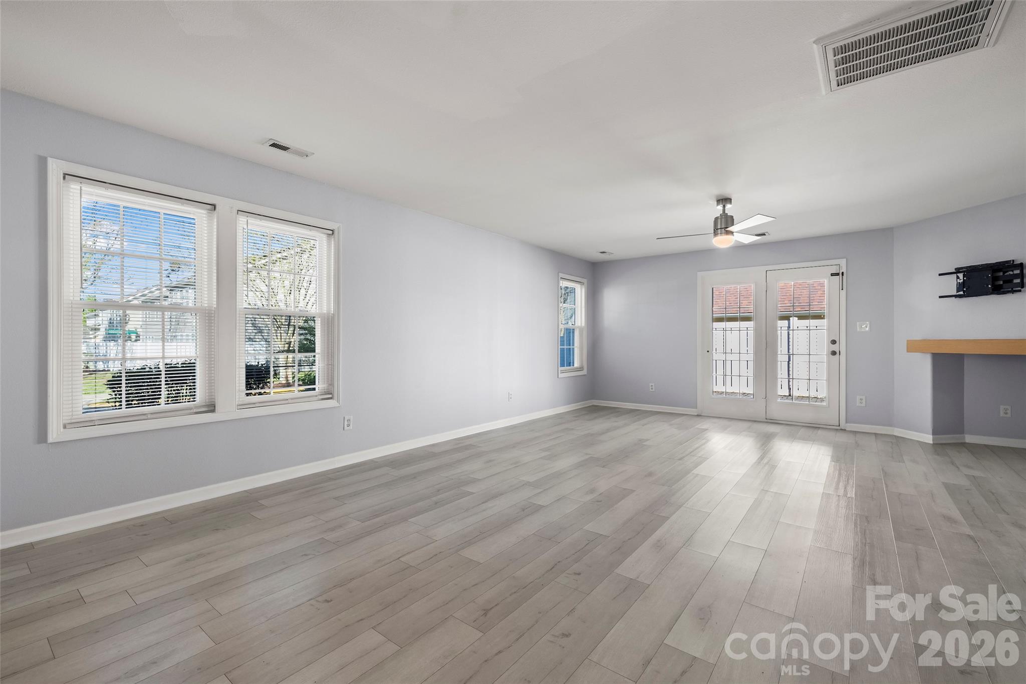 4485 Easywater Lane Fort Mill, SC 29707 - Photo 12 of 29 a view of an empty room with wooden floor and a window