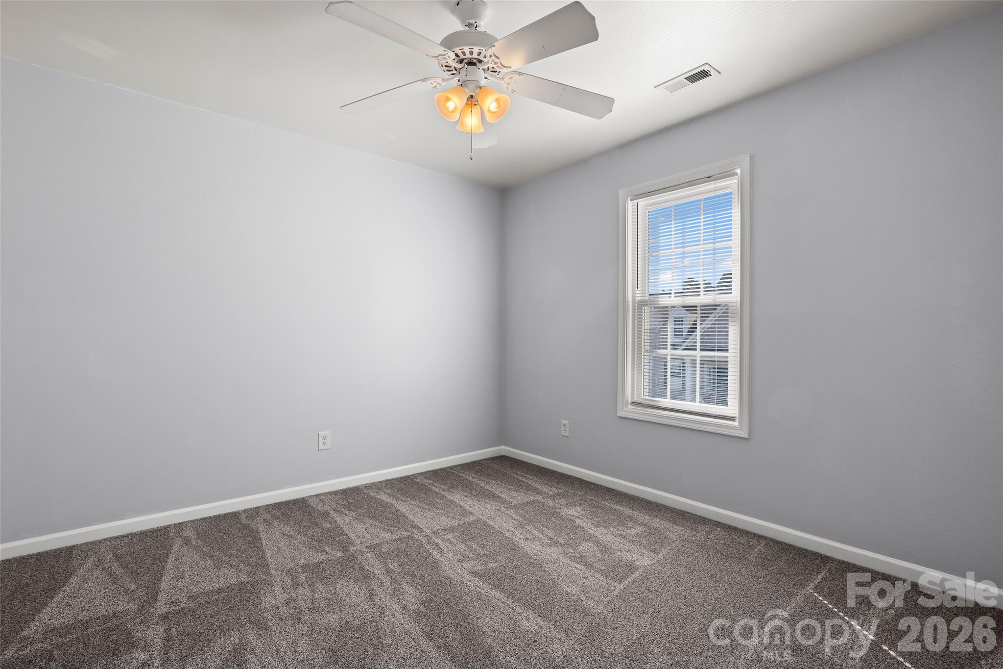 4485 Easywater Lane Fort Mill, SC 29707 - Photo 23 of 29 an empty room with windows and fan