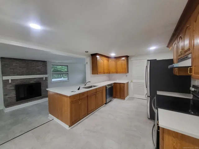 a kitchen with stainless steel appliances granite countertop a stove top oven and sink