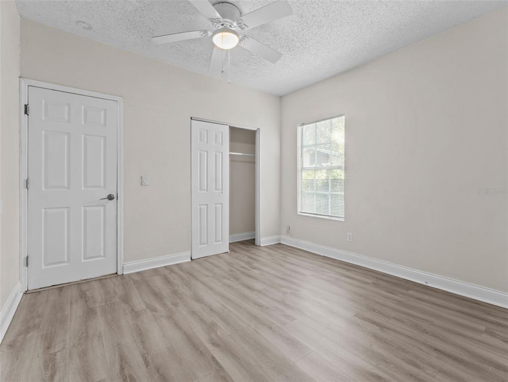 8210 North Klondyke Street, Unit 1 Tampa, FL 33604 - Photo 12 of 34 an empty room with wooden floor fan and windows