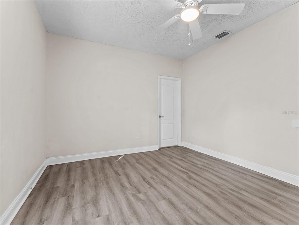 8210 North Klondyke Street, Unit 1 Tampa, FL 33604 - Photo 13 of 34 a view of an empty room with wooden floor