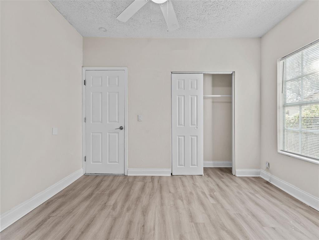 8210 North Klondyke Street, Unit 1 Tampa, FL 33604 - Photo 14 of 34 an empty room with wooden floor and windows