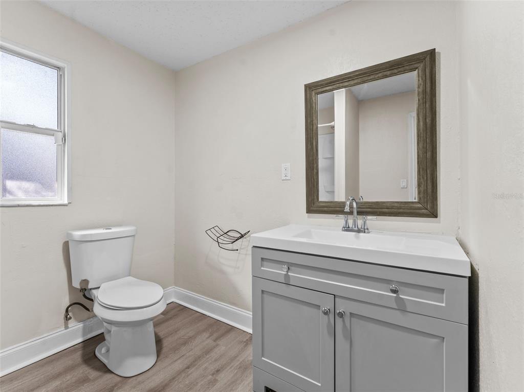 8210 North Klondyke Street, Unit 1 Tampa, FL 33604 - Photo 15 of 34 a bathroom with a toilet sink and mirror