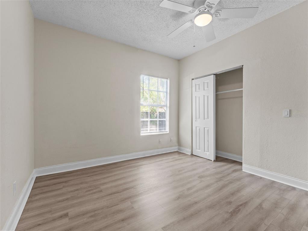 8210 North Klondyke Street, Unit 1 Tampa, FL 33604 - Photo 18 of 34 an empty room with wooden floor and windows