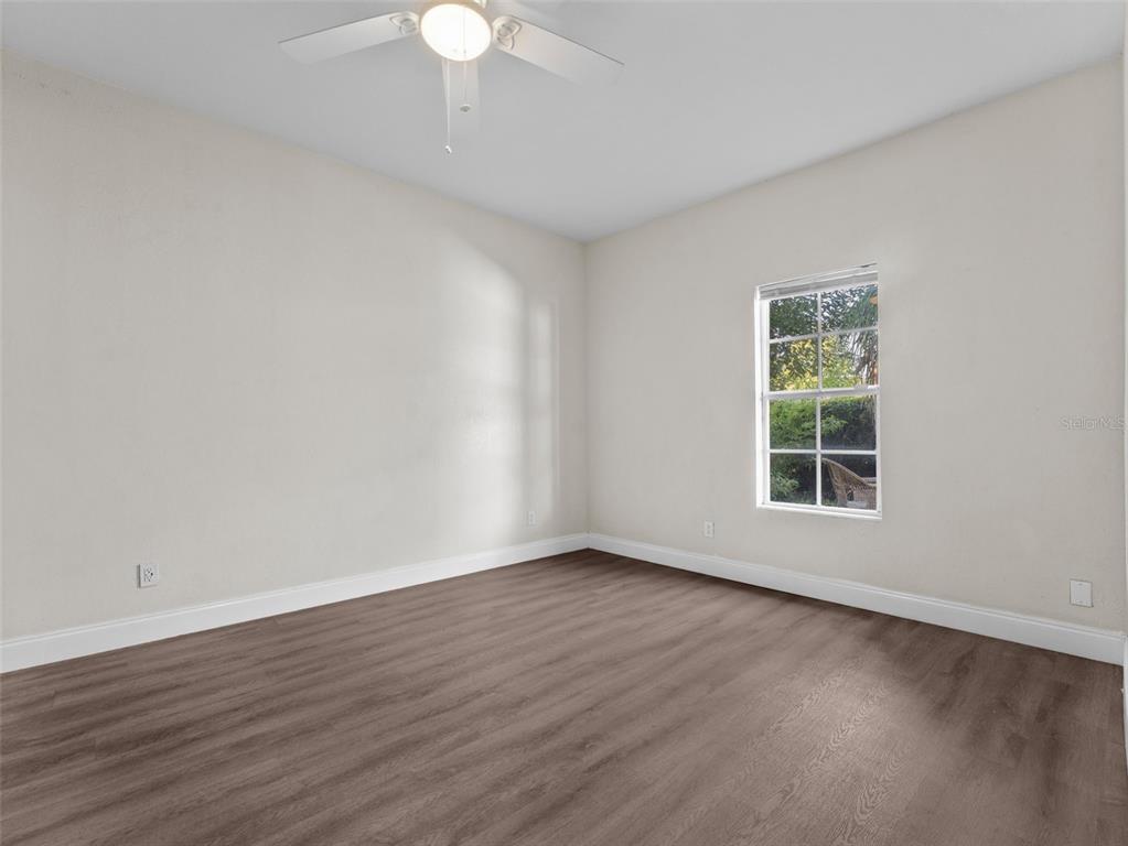 8210 North Klondyke Street, Unit 1 Tampa, FL 33604 - Photo 19 of 34 a view of an empty room with wooden floor and a window