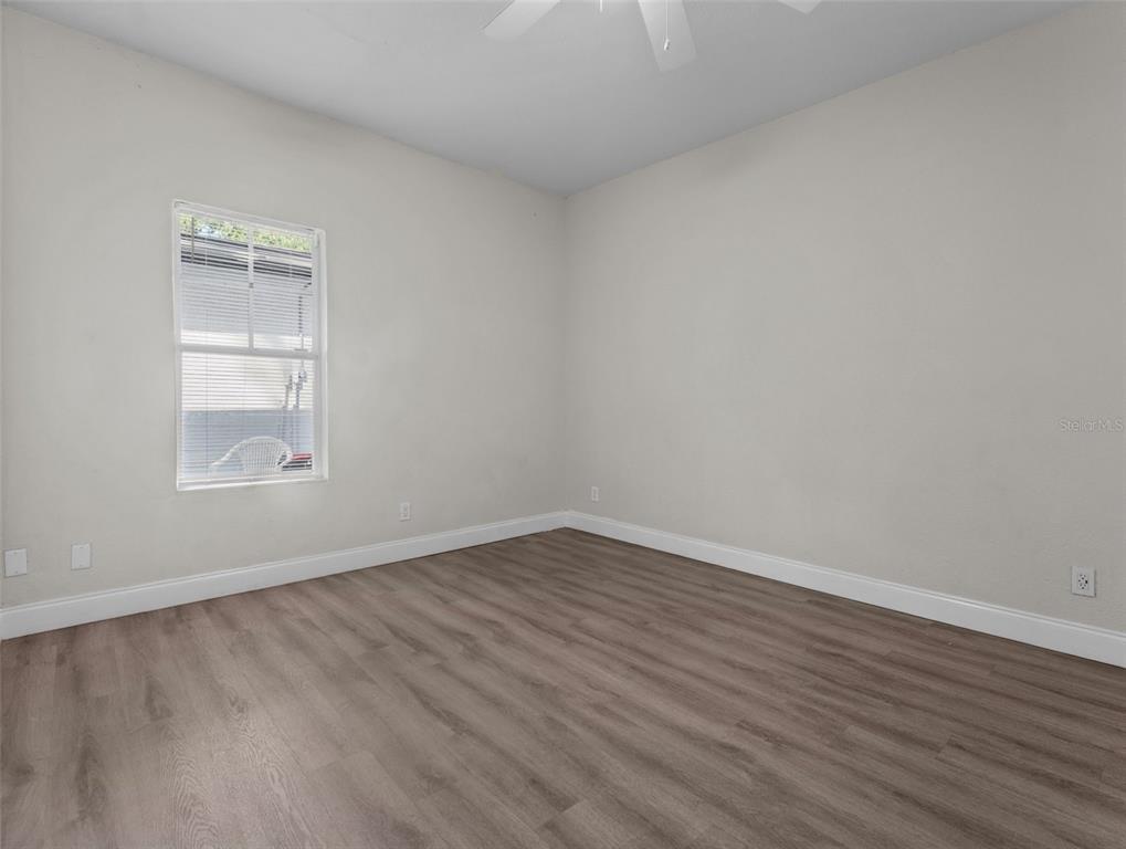 8210 North Klondyke Street, Unit 1 Tampa, FL 33604 - Photo 21 of 34 an empty room with wooden floor and windows
