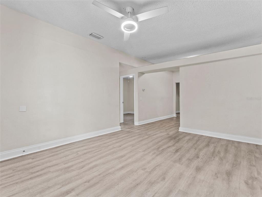 8210 North Klondyke Street, Unit 1 Tampa, FL 33604 - Photo 7 of 34 a view of an empty room with wooden floor