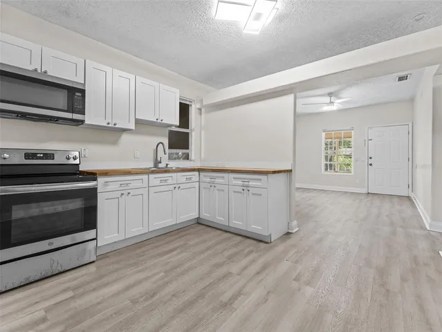 a kitchen with a cabinets and wooden floor